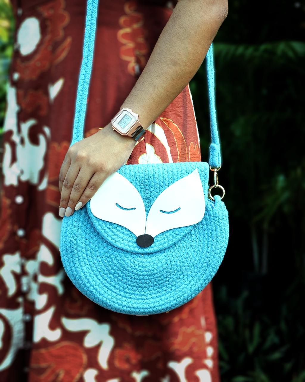 Turquoise round sling bag with snap closure
